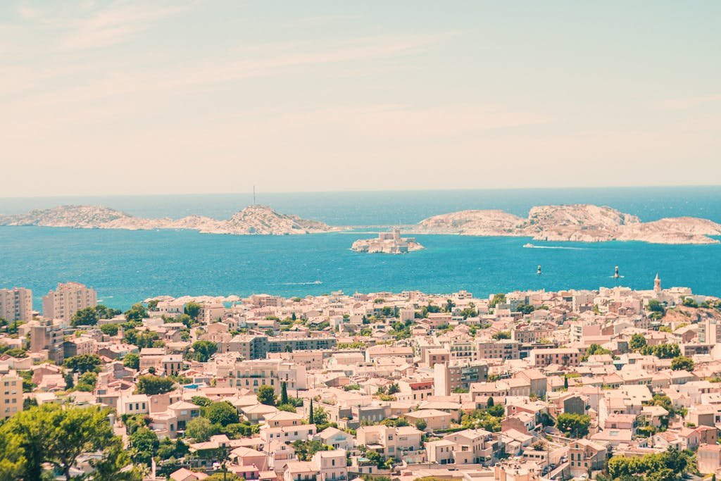 Scenic aerial view of Marseille's coastline and Frioul Islands under a clear sky.